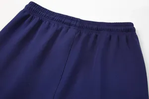 Close-up detail of the elastic waistband on dark blue breathable mesh sports sweatpants