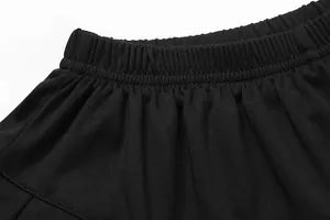 Macro detail view of black kids pleated tennis skirt showing flexible elastic waistband