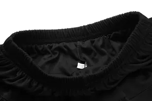 Close-up detail of black pleated sports tennis skirt showing elastic waistband and size M tag