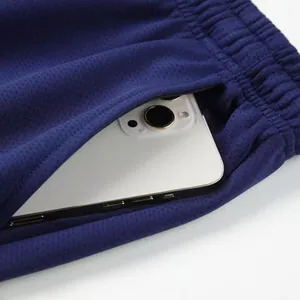 Functional deep blue athletic mesh pants with a spacious side pocket for a smartphone