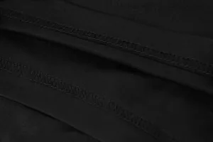 High-quality overlock stitching detail on black pleated sports tennis skirt fabric
