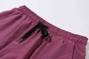 Close-up of elastic waistband with black drawstring on magenta quick-dry yoga pants