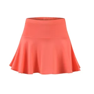 Front view of coral athletic tennis skort with elastic waistband and pleated hem
