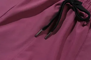 Close-up of drawstring and elastic waistband on purple quick-dry sports trousers