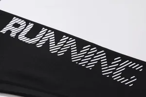 Close-up of white 'RUNNING' print on black quick-dry breathable sports fabric texture