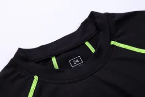 Close-up of neckline on black quick-dry compression training shirt with green seams