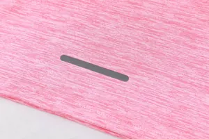 Close-up of pink moisture-wicking fabric with reflective safety strip for sportswear