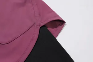 Close-up detail of double-layer women's yoga pants showing the side slit and fabric texture