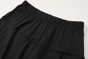 Detailed close-up of high-quality elastic waistband on black pleated athletic skort