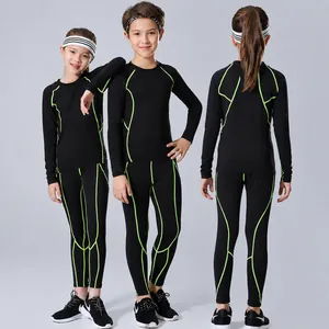 Professional kids black compression suit with neon green piping for sports training