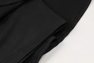 Macro detail of black sports tennis skirt showing quality fabric texture and stitching.