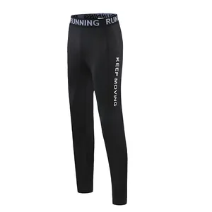 Detailed view of the side printed KEEP MOVING text and waistband on black sports tights
