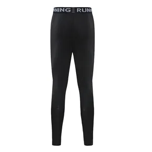 Macro view of black compression leggings with RUNNING waistband detail
