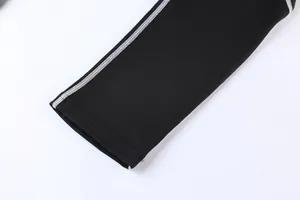 Close-up detail of durable white flatlock stitching on black elastic compression pants