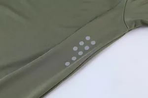 Close-up of the reflective dots on an olive green men's athletic milk silk sport t-shirt.