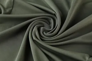 Close-up of dark green stretch milk silk fabric texture for men's sports T-shirt.