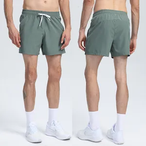 Full front and back view of olive green quick-dry athletic running shorts on male model