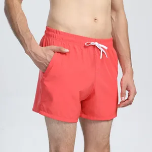 Detail view of coral red quick-dry athletic shorts for unisex running and fitness training