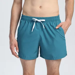 Detail view of unisex quick-dry blue running shorts with white drawstring waist.