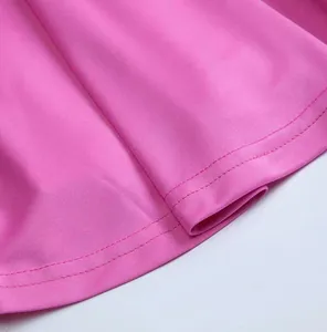 Macro view of the double-stitched hem and quick-dry fabric texture on pink girl's skort