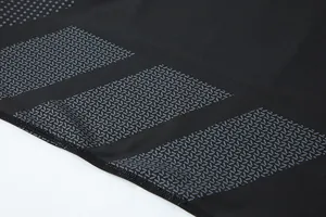 Close-up view of the quick-drying compression shirt fabric with grey graphic patterns.