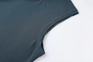 Close-up detail of the breathable mesh fabric and armhole stitching on a sports tank top.