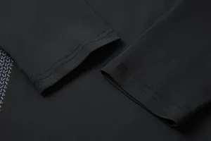 Macro view of high-quality double stitching on black long sleeve compression workout shirt