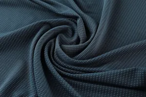 Macro view showing the breathable quick-dry mesh texture of men's athletic jersey fabric