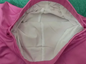Close-up detail of white breathable inner lining on pink girls sports tennis skirt
