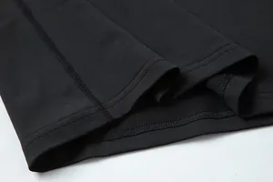 Detail view of double-stitched hem on black quick-dry sports compression shirt