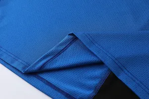 Macro view showing breathable mesh texture and stitching of blue sports vest