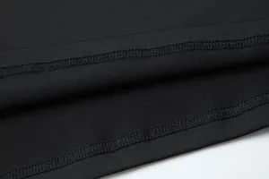Detailed close-up showing the double-stitched hem on a black quick-dry sports compression shirt