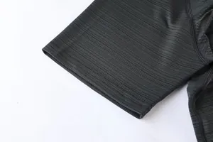 Close-up detail of grey quick-dry sports T-shirt sleeve with fine durable stitching