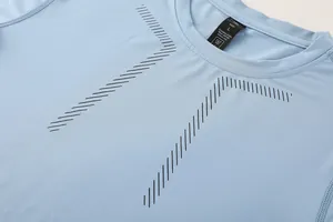 Detail shot of blue quick-dry compression shirt neckline and printed chest pattern.