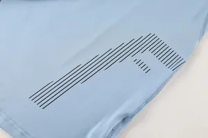Detailed view of black geometric line print on light blue quick-dry compression top