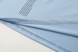 Macro view showing the high-quality stitching detail of a light blue men's compression shirt