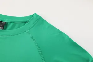 Close-up of the round neckline and stitching on a green quick-dry sports shirt