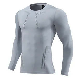 Detail view of light gray men's long sleeve compression athletic shirt for gym training