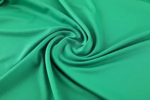 Macro detail showing the texture of green quick-drying breathable fabric for sports wear