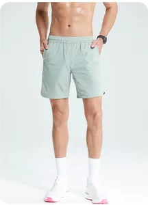 Detail view of light green men's quick-dry sports shorts for running and fitness training.