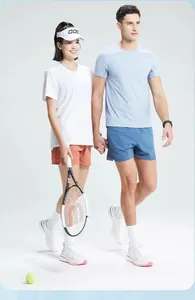 Detail of models wearing athletic quick-dry T-shirts in a tennis setting scene.