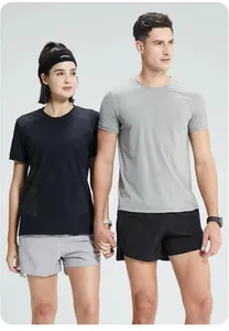 Couple se tenant la main portant des t-shirts de sport respirants à séchage rapide en gris et noir