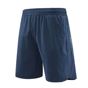 Close-up of men's quick-dry navy blue sports shorts with mesh panel and side pockets