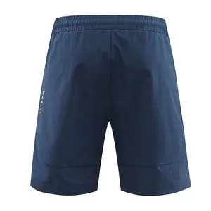 Back view of navy blue men's quick-dry sports shorts featuring breathable mesh hem detail