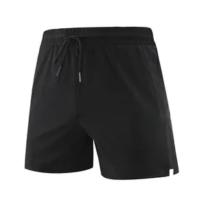 Detailed view of black quick-dry men's sports shorts with drawstring and side slits