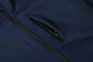 Close-up detail of navy blue men's sports jacket featuring a secure zipper pocket