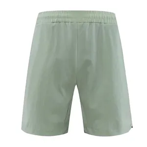 Back view of light green quick-dry men's athletic shorts with elastic waistband