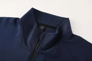 Detailed view of navy blue men's sports jacket stand collar with zip and textured fabric
