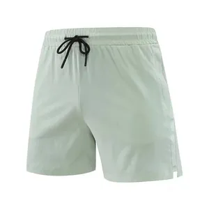 Detail view of men's quick-dry running shorts in mint green with elastic drawstring waist.