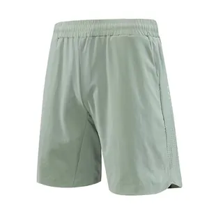 Detail view of light green quick-dry men's athletic shorts with laser-cut vents.